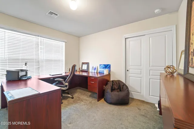 a room with wooden floor pool table and a rug
