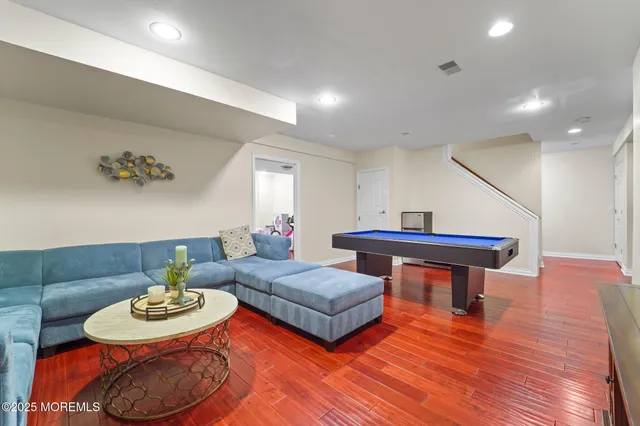 a bedroom with furniture and a wooden floor