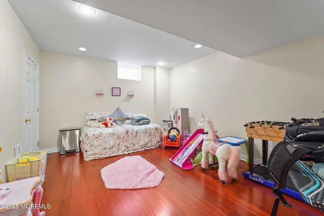 a view of a patio with couches potted plants and wooden floor