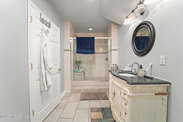 a view of a patio with a table and chairs under an umbrella with a small yard