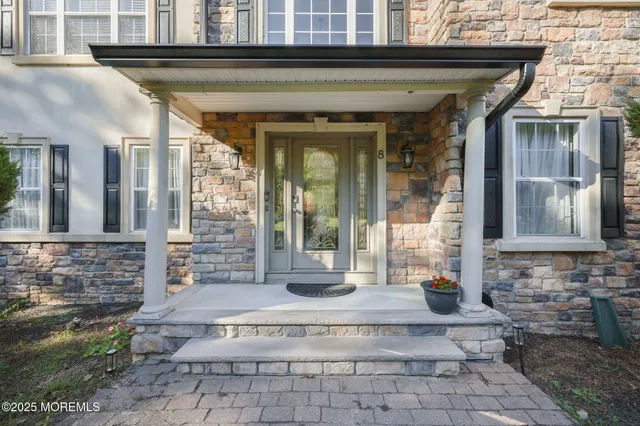 a view of an entryway with wooden floor and windows