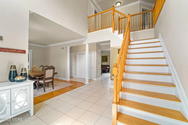 a view of a dining room with furniture and a potted plant