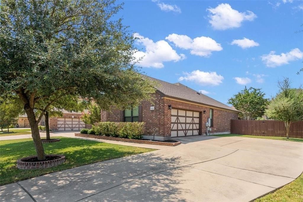 19128 Pencil Cactus Drive Pflugerville, TX 78660 - Photo 1 of 1 a front view of a house with garden