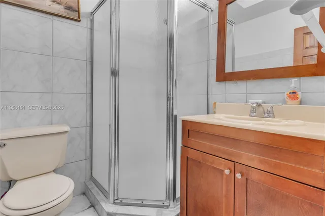 a bathroom with a sink mirror vanity and toilet