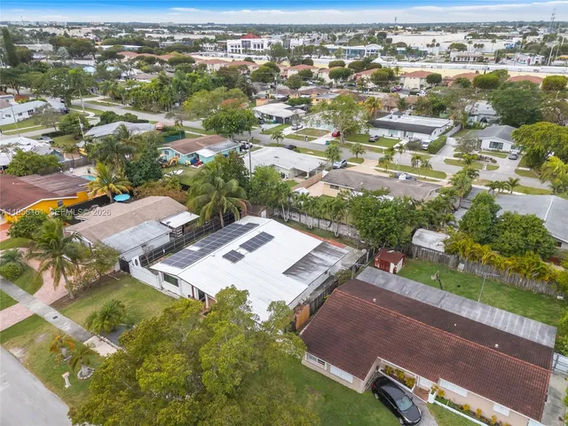 an aerial view of a residential houses with outdoor space and swimming pool