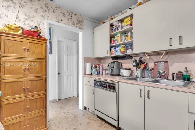 a kitchen with stainless steel appliances granite countertop a sink and cabinets
