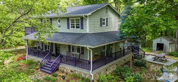 a aerial view of a house with a yard table and chairs