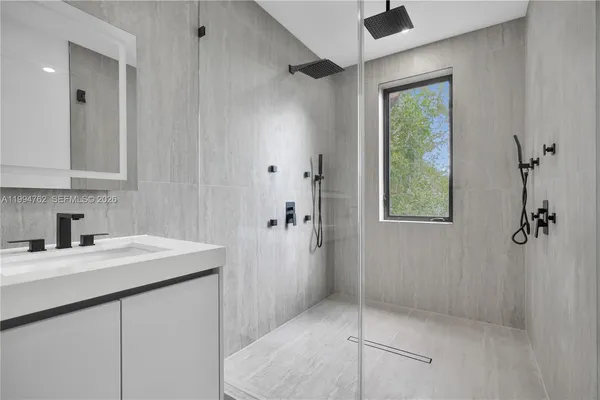 a bathroom with a sink and a shower