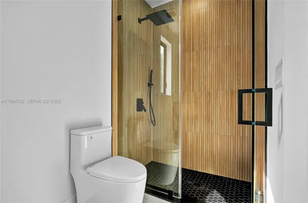 a bathroom with a toilet and a shower