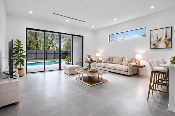 a living room with furniture and a large window