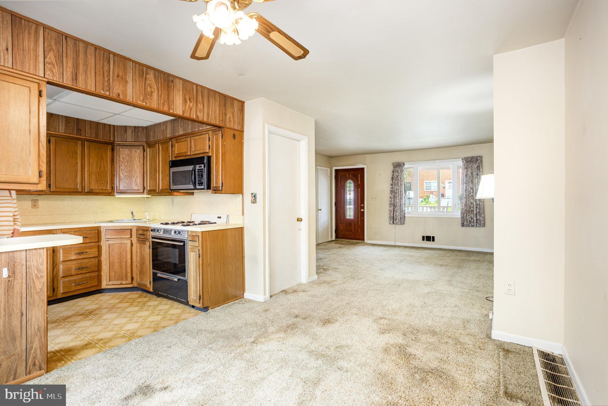 104 Bladen Road Baltimore, MD 21221 - Photo 6 of 16 a view of a kitchen cabinets a sink and a window
