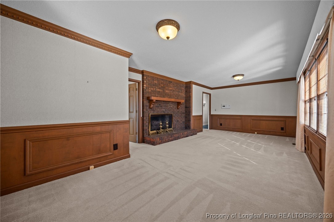 4943 Highway 301 Benson, NC 27504 - Photo 24 of 49 a view of an empty room with wooden floor and fireplace