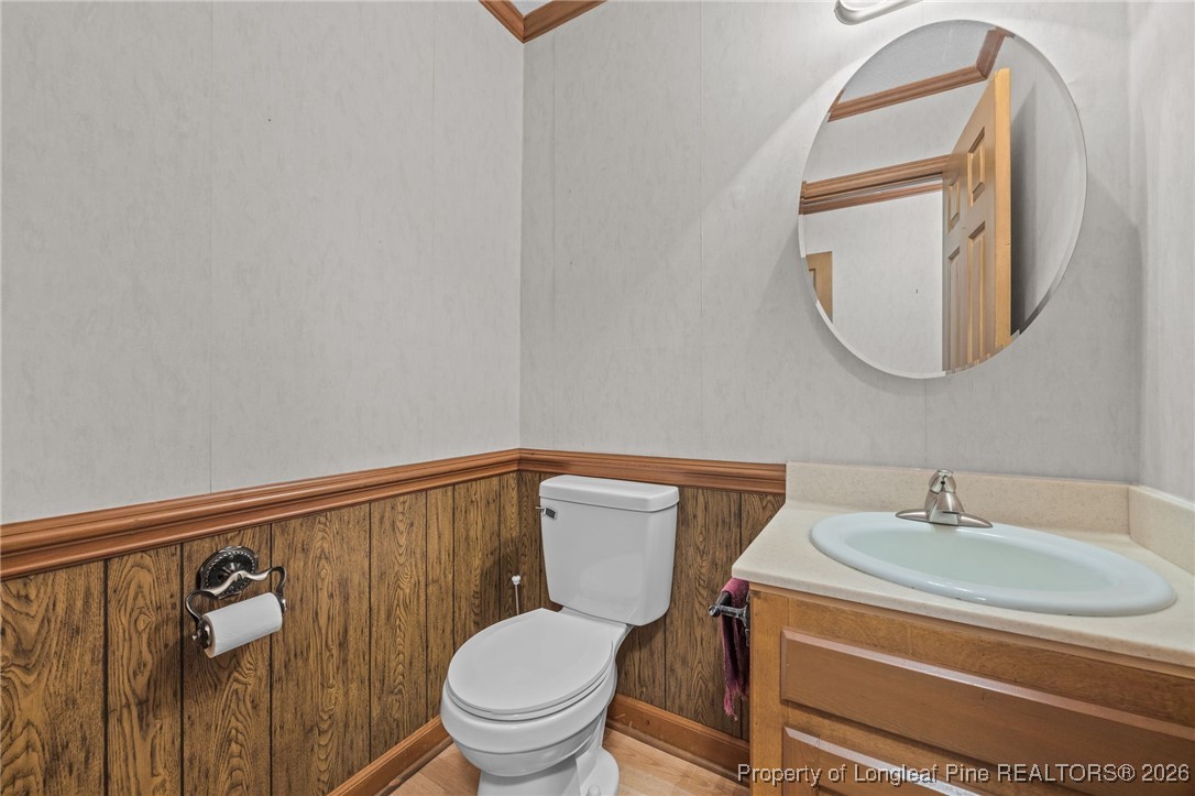 4943 Highway 301 Benson, NC 27504 - Photo 34 of 49 a bathroom with a toilet sink and mirror