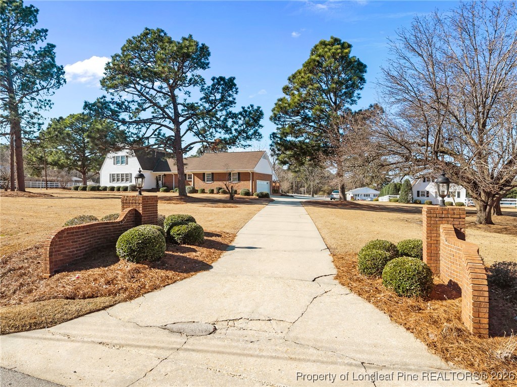 4943 Highway 301 Benson, NC 27504 - Photo 44 of 49 a view of swimming pool outdoor seating and trees in the background