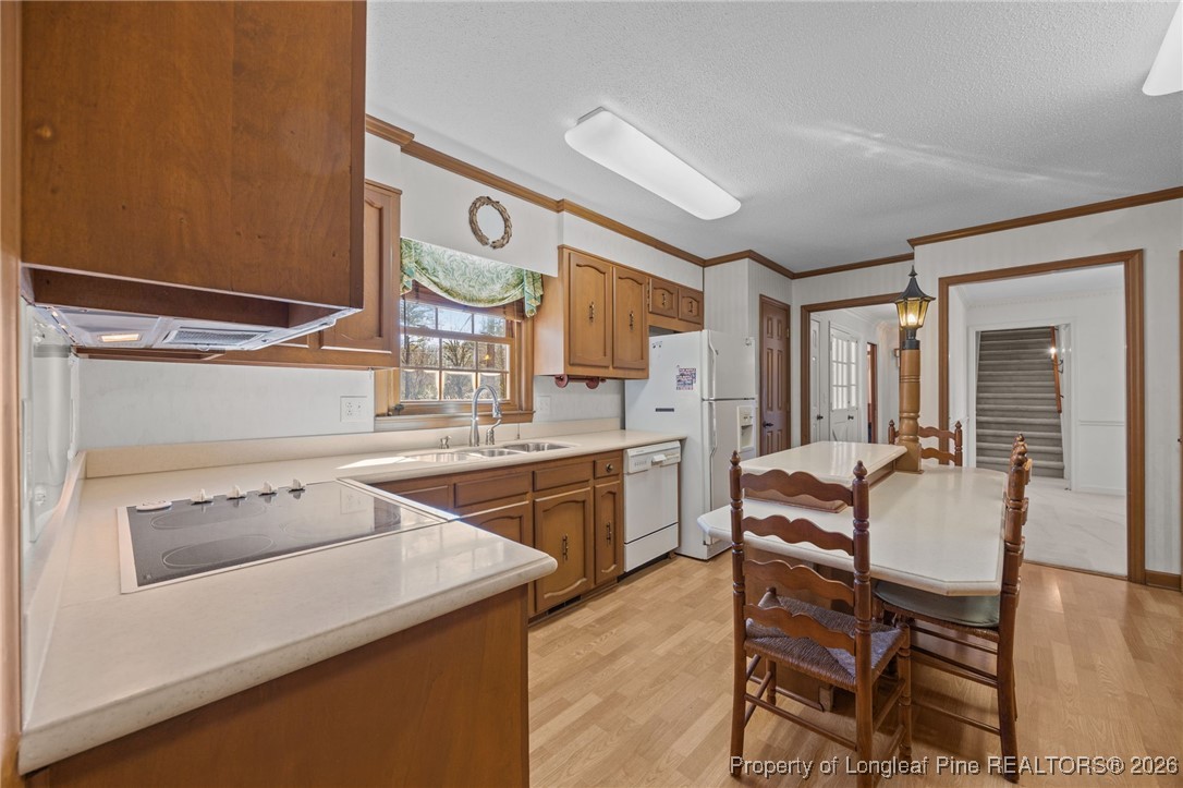 4943 Highway 301 Benson, NC 27504 - Photo 8 of 49 a kitchen with a table chairs stove and cabinets