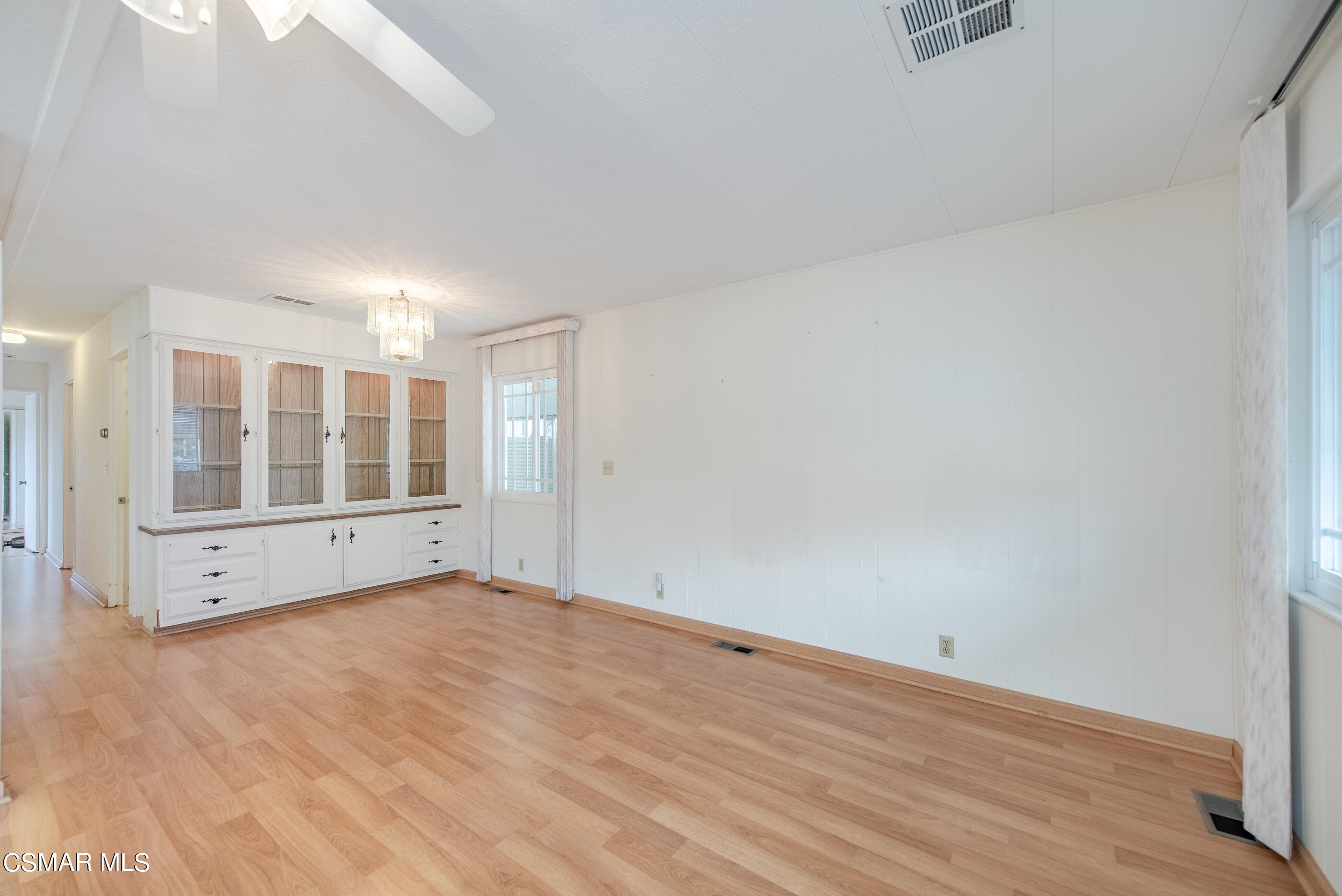 3 Gitana Avenue, Unit 151 Camarillo, CA 93012 - Photo 12 of 12 a view of an empty room with wooden floor and a window