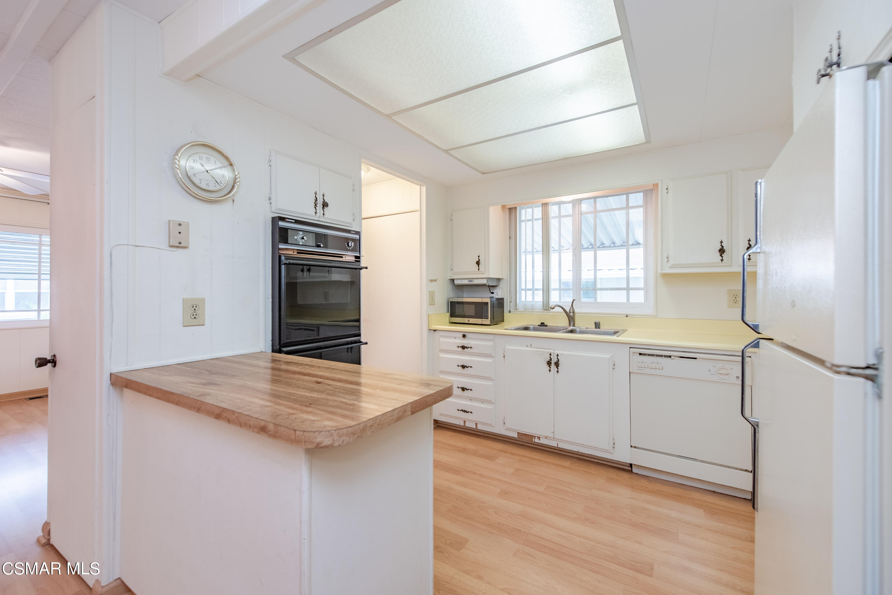 3 Gitana Avenue, Unit 151 Camarillo, CA 93012 - Photo 8 of 12 a kitchen with white cabinets and white appliances