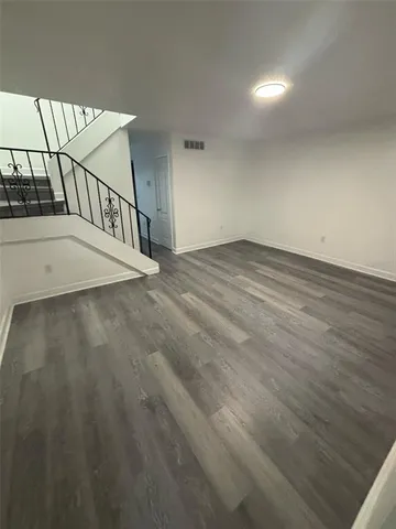 a view of a room with a ceiling fan and window