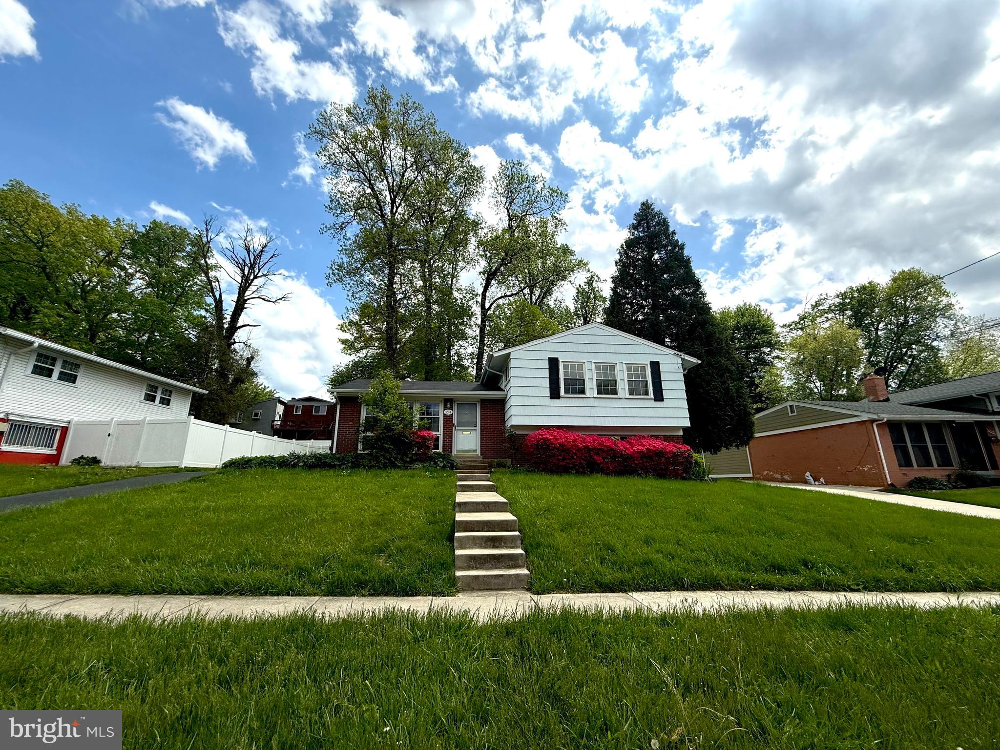 a view of house with garden space and street view