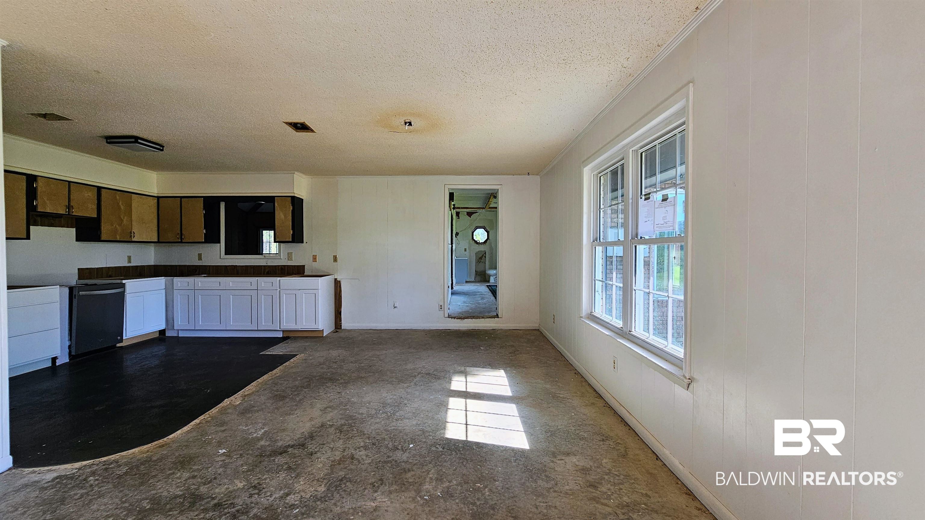 18824 Highway 41 Brewton, AL 36426 - Photo 5 of 40 Open-concept living area featuring a kitchen with white lower cabinetry and a built-in dishwasher