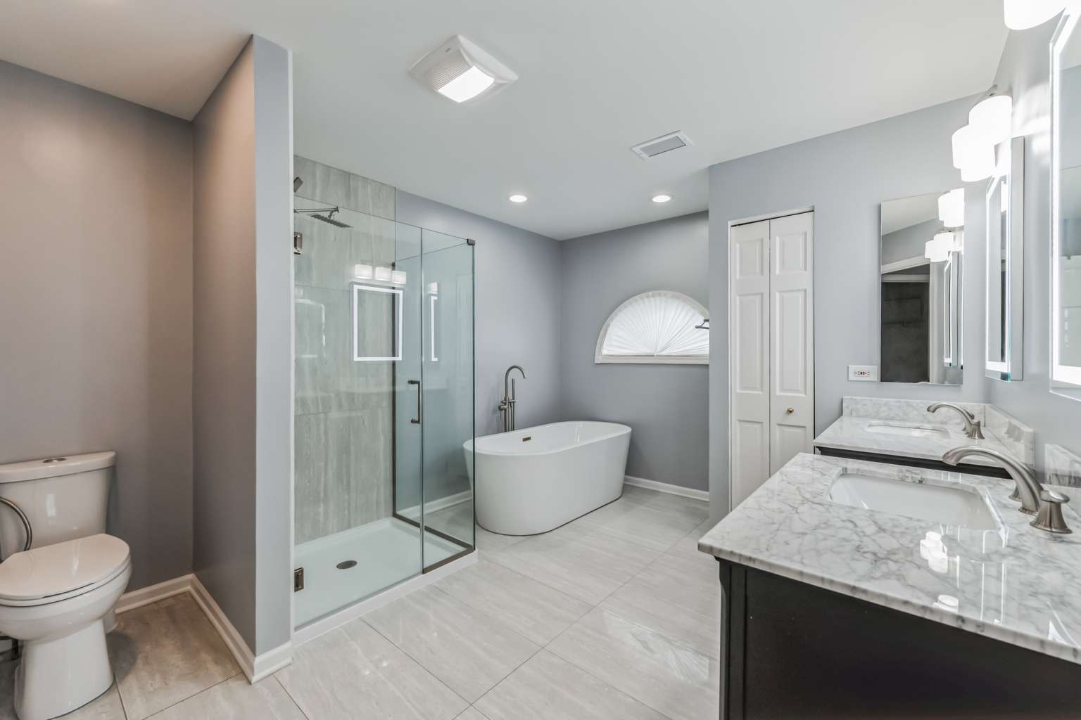 1113 Stonegate Court Bartlett, IL 60103 - Photo 14 of 25 a spacious bathroom with a granite countertop sink a toilet a mirror and shower
