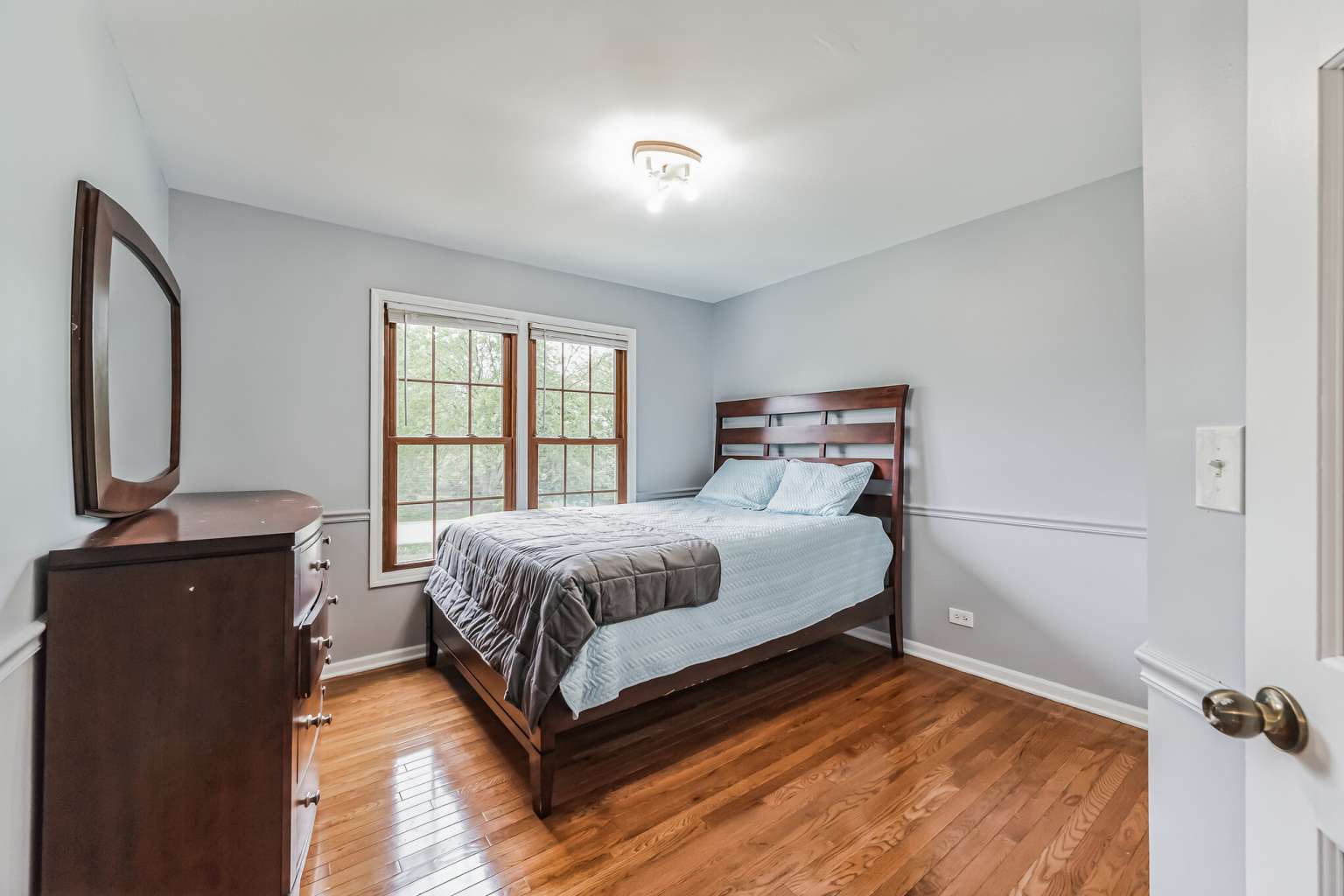 1113 Stonegate Court Bartlett, IL 60103 - Photo 18 of 25 a bedroom with a bed window and mirror