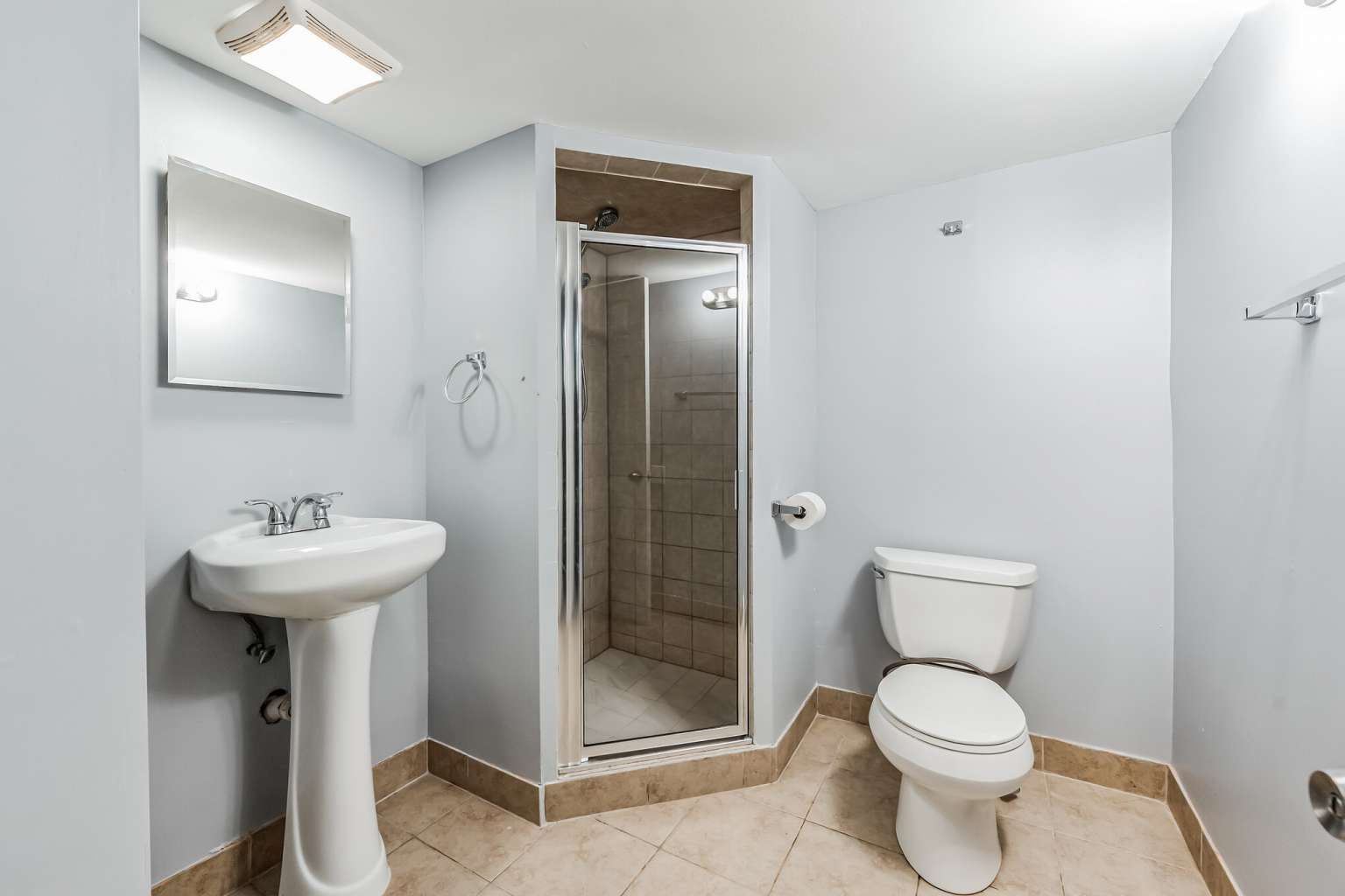 1113 Stonegate Court Bartlett, IL 60103 - Photo 23 of 25 a bathroom with a toilet sink and shower