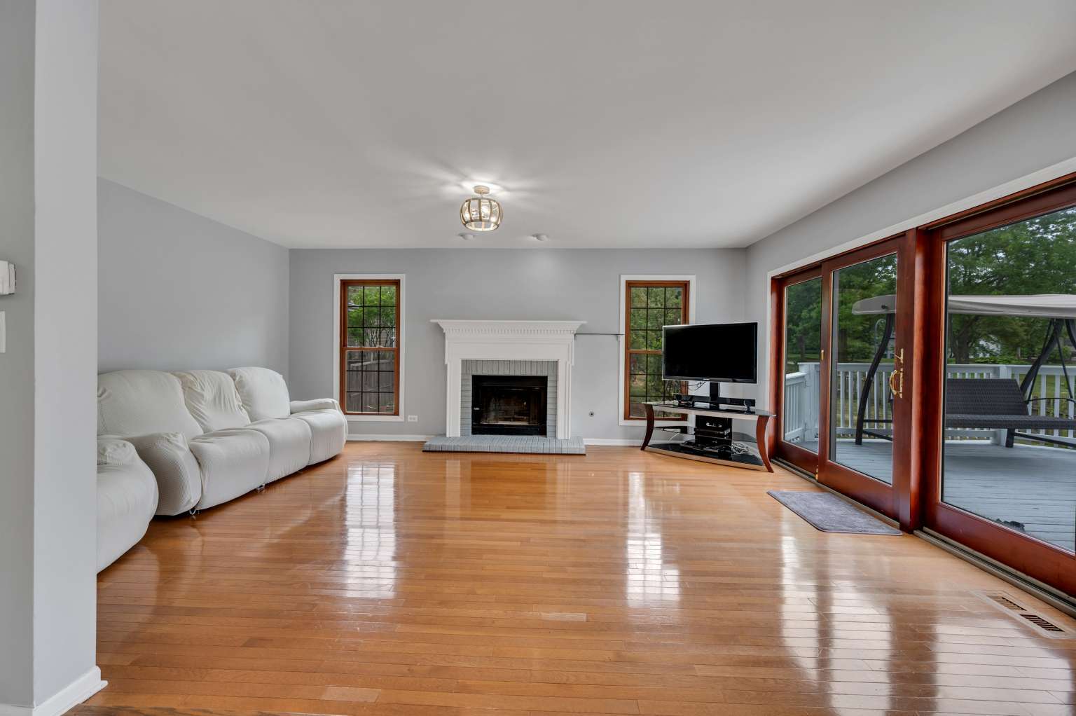 1113 Stonegate Court Bartlett, IL 60103 - Photo 9 of 25 a living room with furniture a flat screen tv and a fireplace