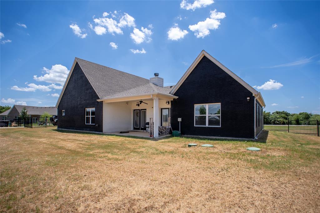 311 Dobbs Trail Springtown, TX 76082 - Photo 4 of 33 a view of a house with a yard and entertaining space