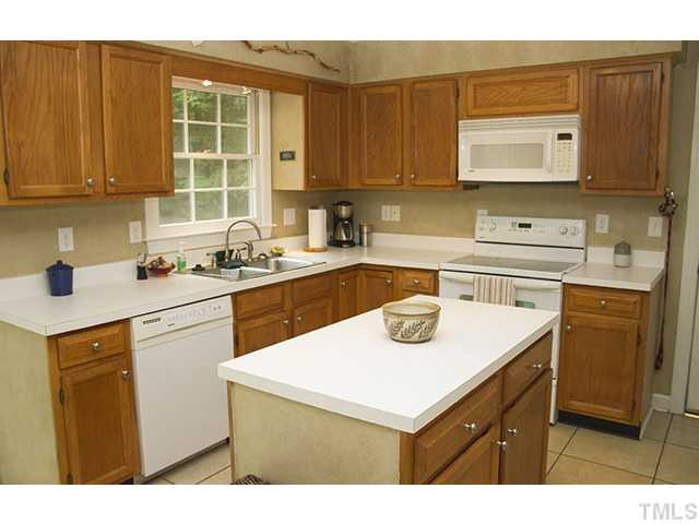 21 Swallows Ridge Court Durham, NC 27713 - Photo 16 of 25 a kitchen with a sink cabinets and appliances