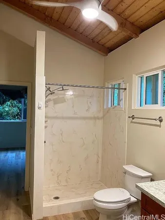 a white toilet sitting next to a bathroom sink