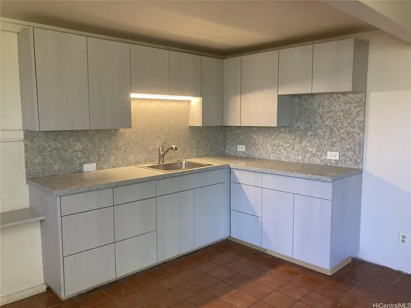 a kitchen with a sink cabinets and window