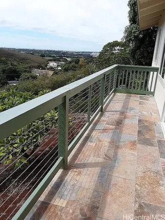 a view of a balcony with wooden floor