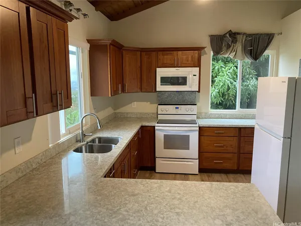 a kitchen that has a sink and a stove in it