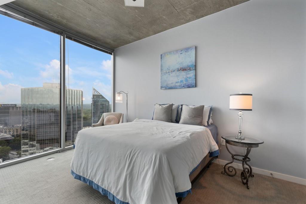 3324 Peachtree Road Northeast, Unit 2918 Atlanta, GA 30326 - Photo 12 of 27 a bedroom with a bed lamp and window