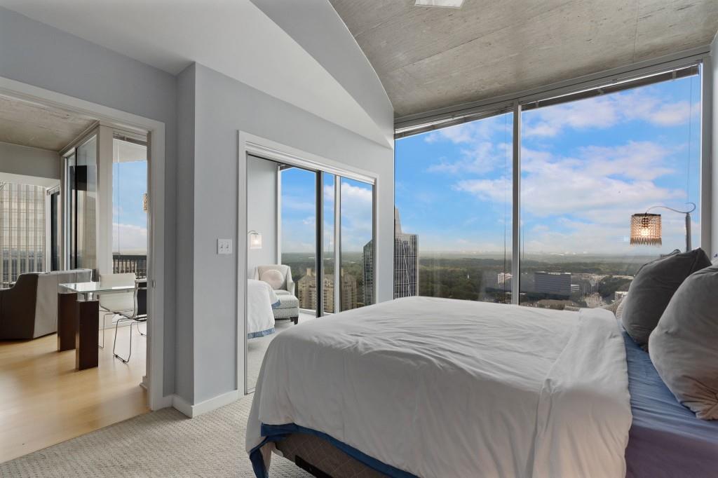 3324 Peachtree Road Northeast, Unit 2918 Atlanta, GA 30326 - Photo 13 of 27 a bedroom with a large bed and a large window