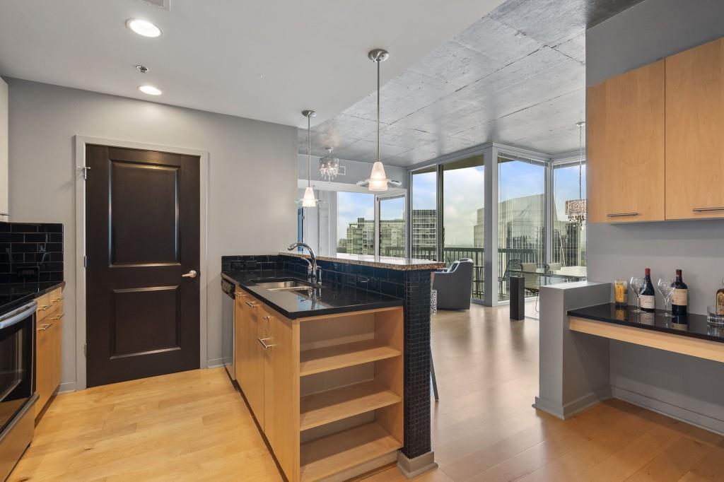 3324 Peachtree Road Northeast, Unit 2918 Atlanta, GA 30326 - Photo 5 of 27 a kitchen with stainless steel appliances granite countertop a stove and a refrigerator