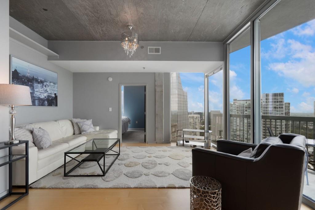 3324 Peachtree Road Northeast, Unit 2918 Atlanta, GA 30326 - Photo 9 of 27 a living room with furniture and a floor to ceiling window