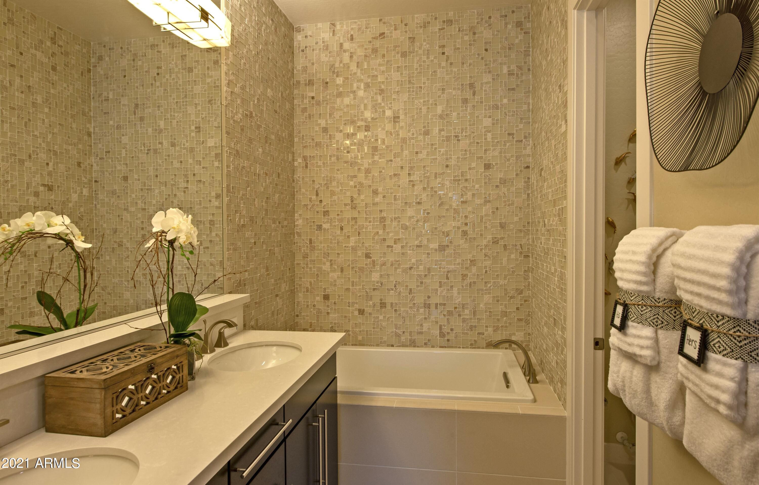 6565 East Thomas Road, Unit 1042 Scottsdale, AZ 85251 - Photo 10 of 22 a bathroom with a sink a toilet and shower
