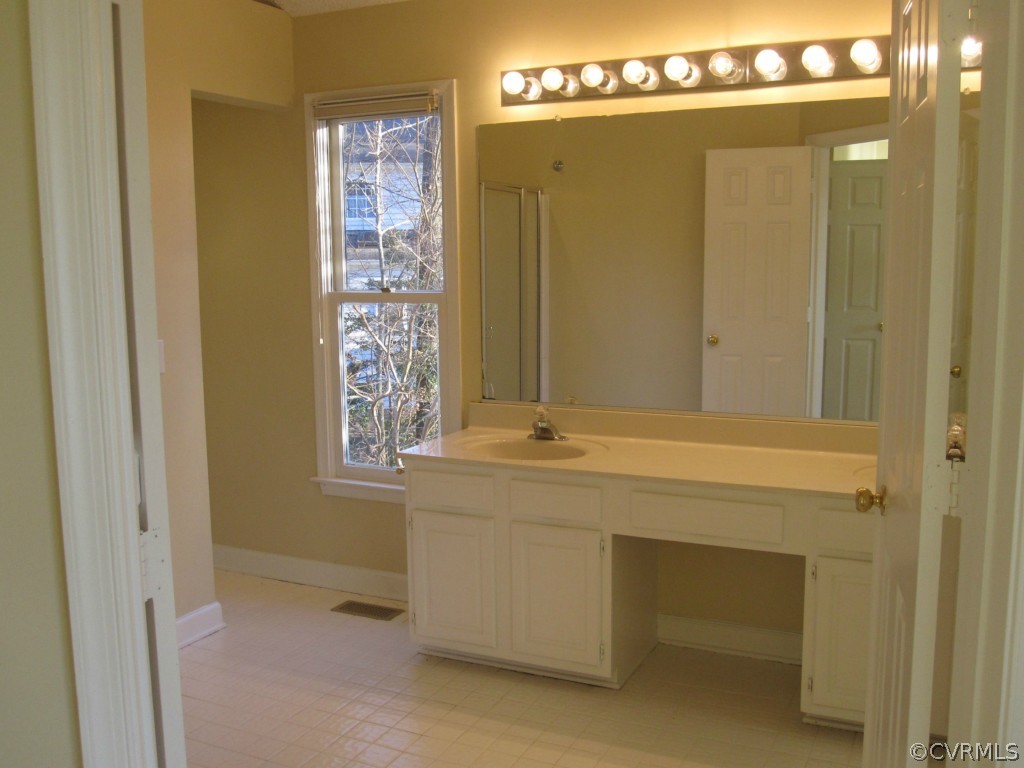 2913 Cove Ridge Trace Midlothian, VA 23112 - Photo 13 of 24 a bathroom with a sink and a mirror