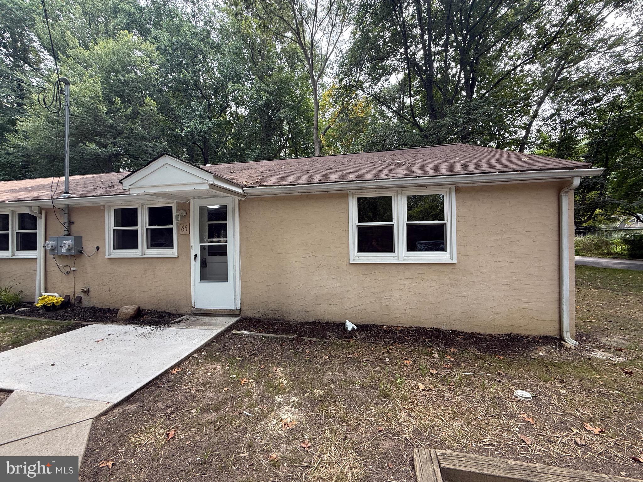 65 Springhill Road Mantua, NJ 08051 - Photo 1 of 10 a front view of a house with a garden