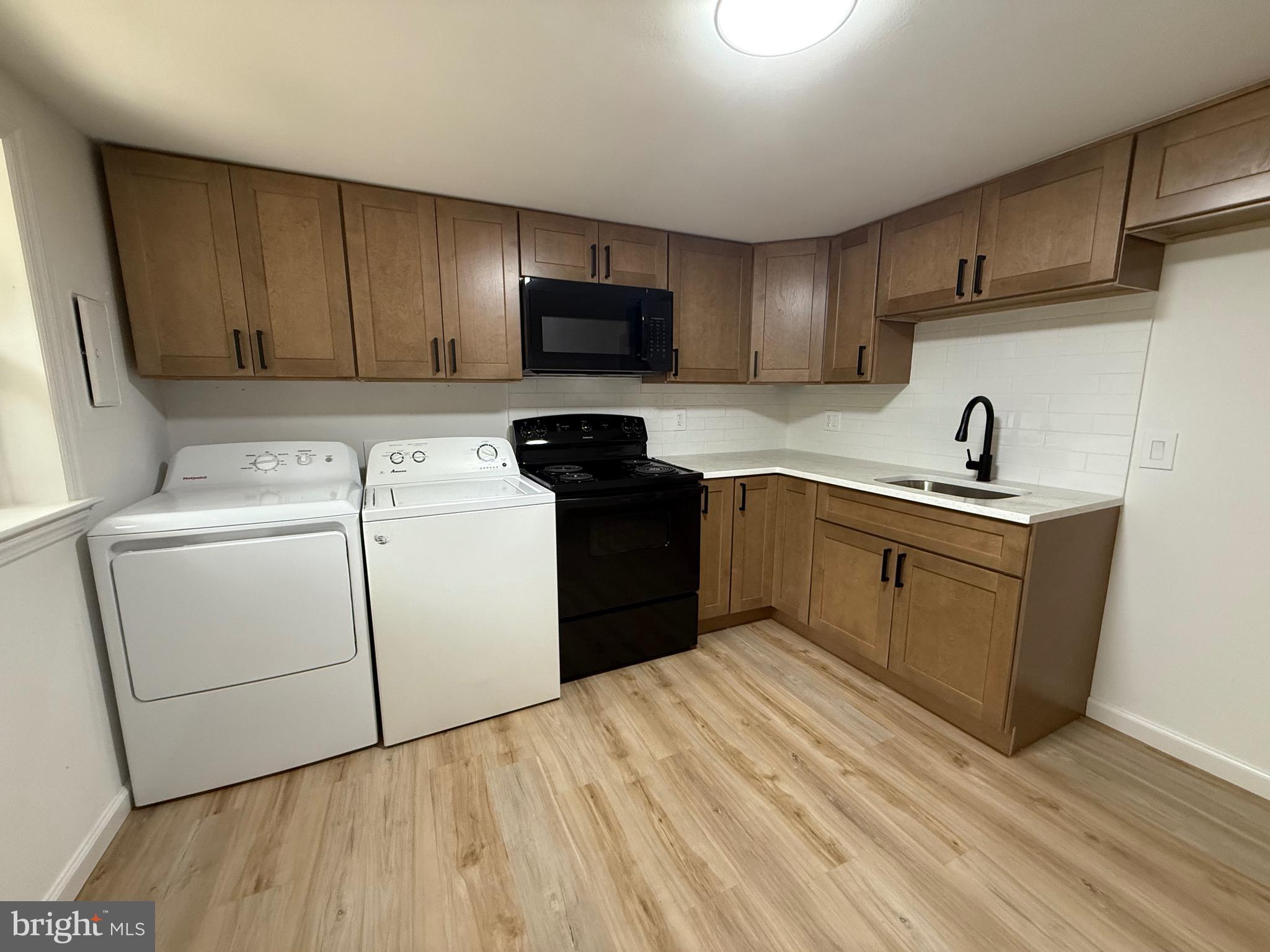 65 Springhill Road Mantua, NJ 08051 - Photo 2 of 10 a kitchen with a sink a stove and refrigerator