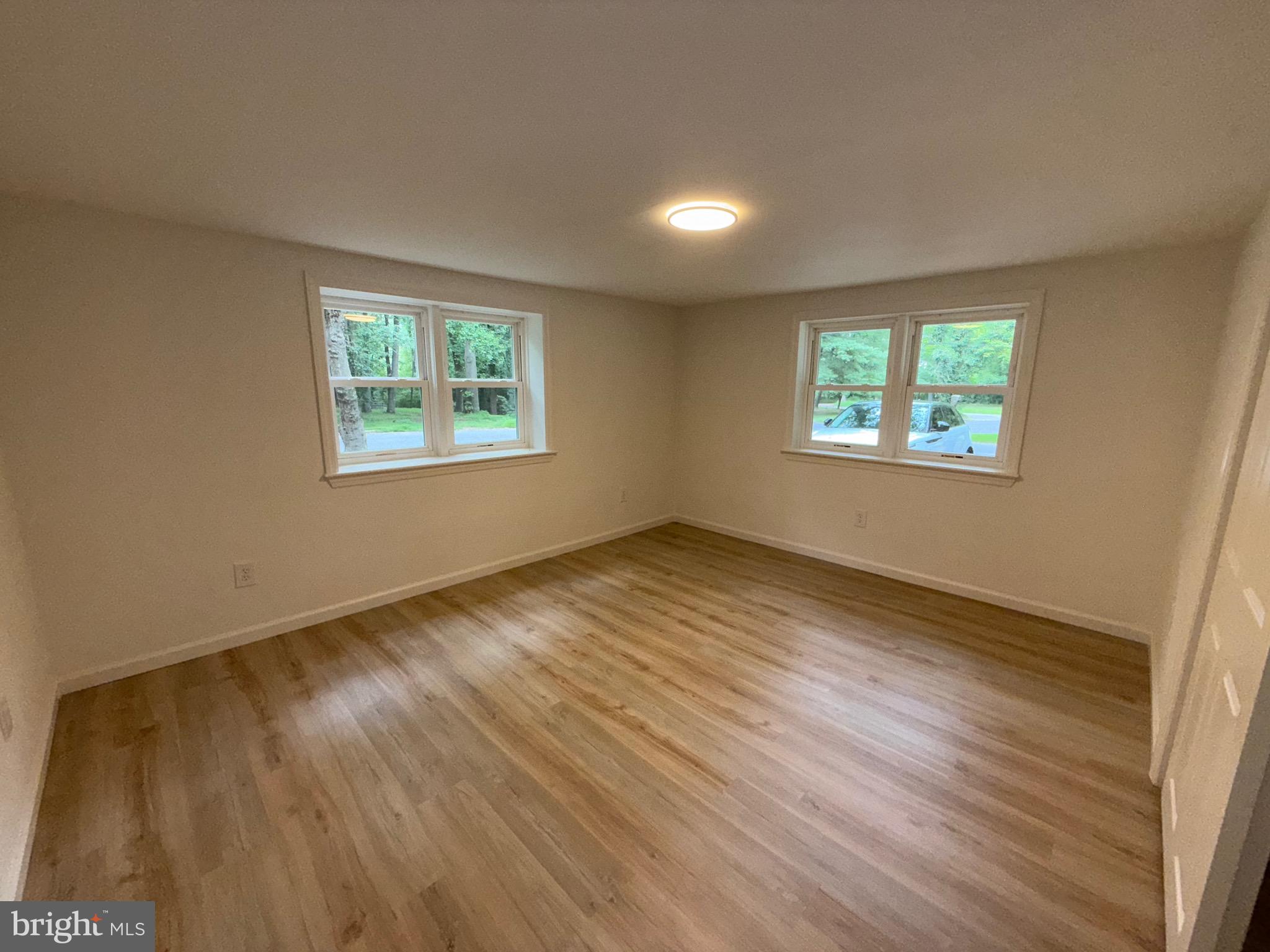 65 Springhill Road Mantua, NJ 08051 - Photo 7 of 10 a view of an empty room with wooden floor and a window