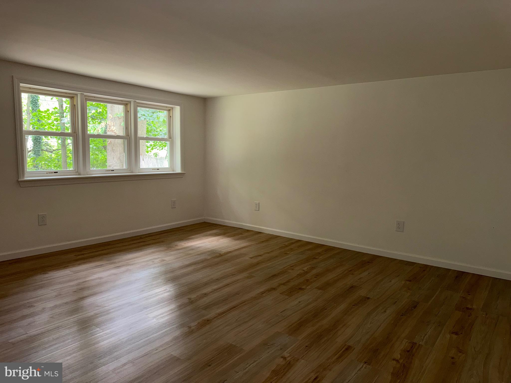65 Springhill Road Mantua, NJ 08051 - Photo 8 of 10 a view of an empty room with wooden floor and a window