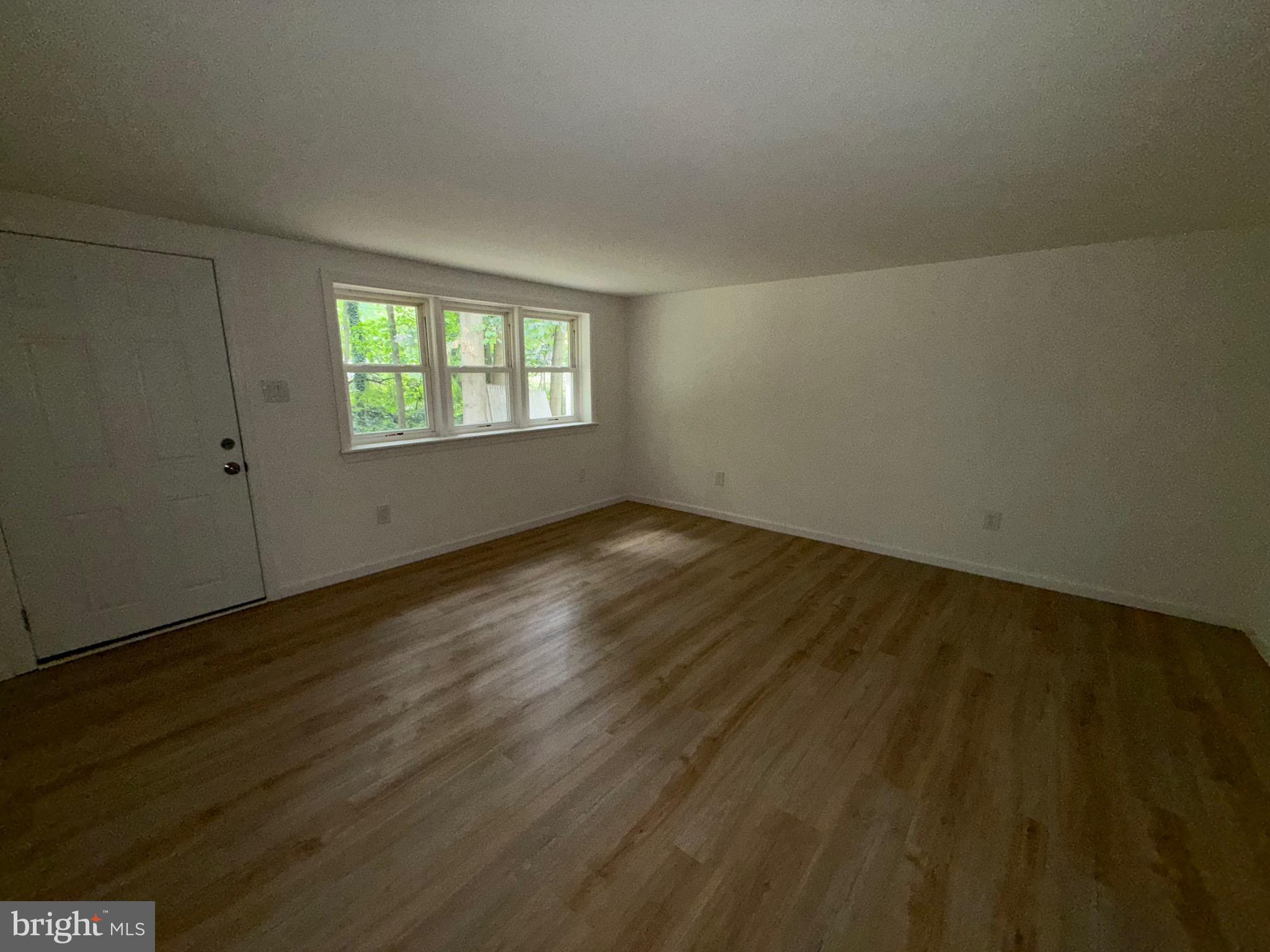 65 Springhill Road Mantua, NJ 08051 - Photo 9 of 10 an empty room with wooden floor and windows