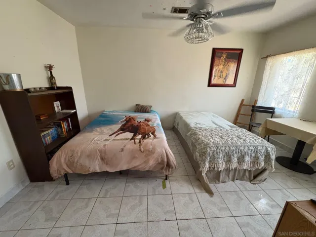 a bedroom with a bed a couch and window