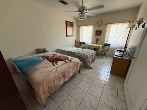 a bedroom with a bed and a large mirror in a bedroom