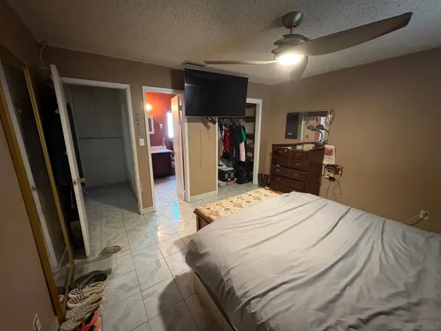 a bathroom with a granite countertop toilet and a shower