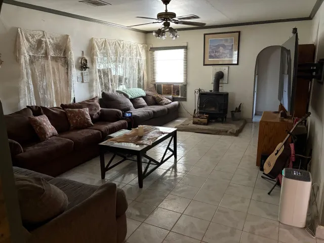 a living room with furniture a ceiling fan and a window