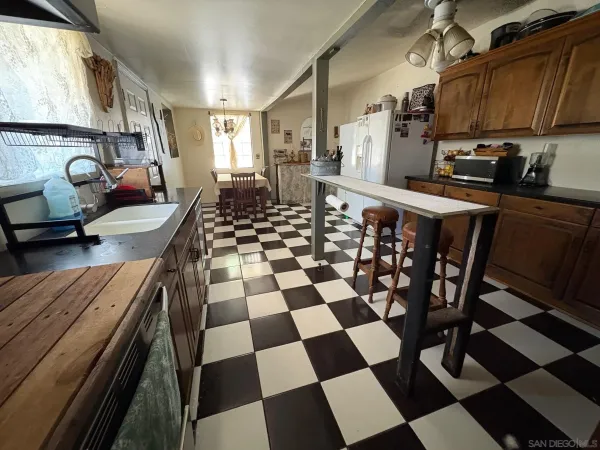 a kitchen with a stove a sink and a cabinets